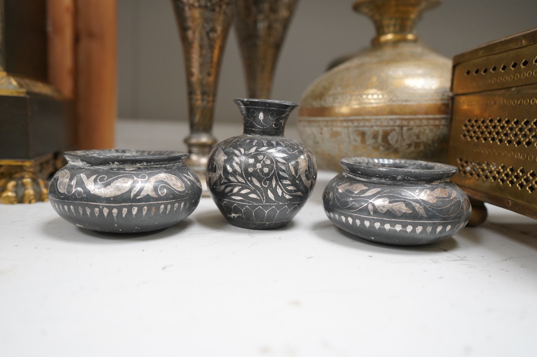 A collection of Indian brass and metalware to include a pierced casket box and Bidriware vases, largest 33cm high